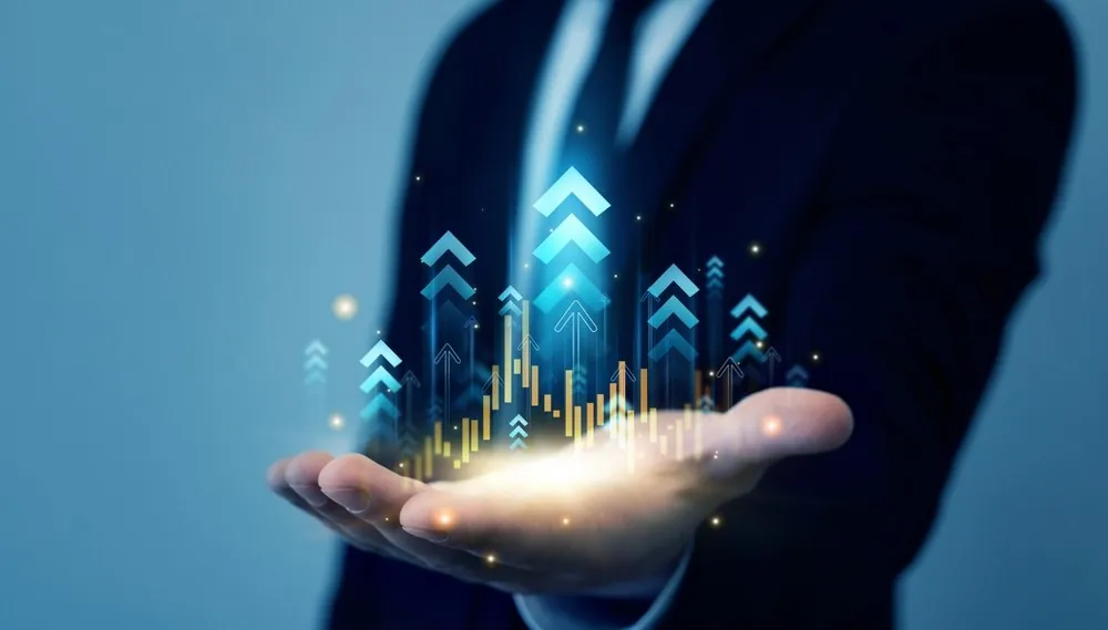 A trader’s hand with glowing upward arrows representing market growth.